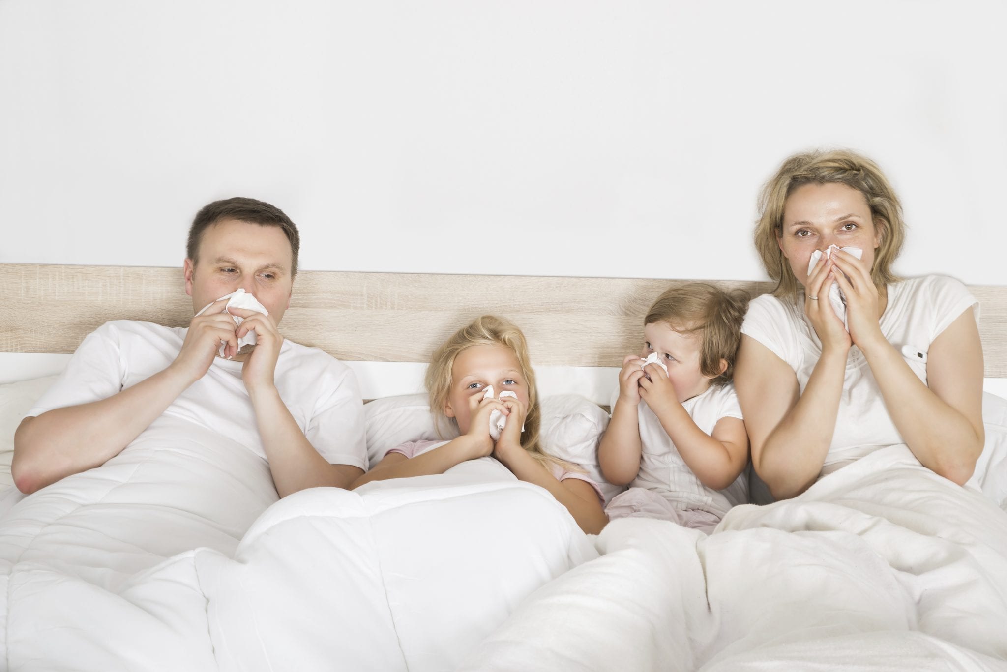 sick family lying in bed