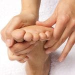 hands giving reflexology treatment Reflexology Healing Medfield MA