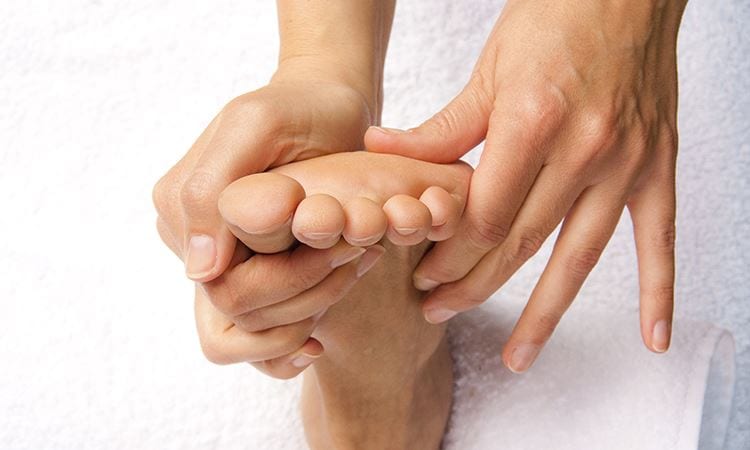 hands giving reflexology treatment