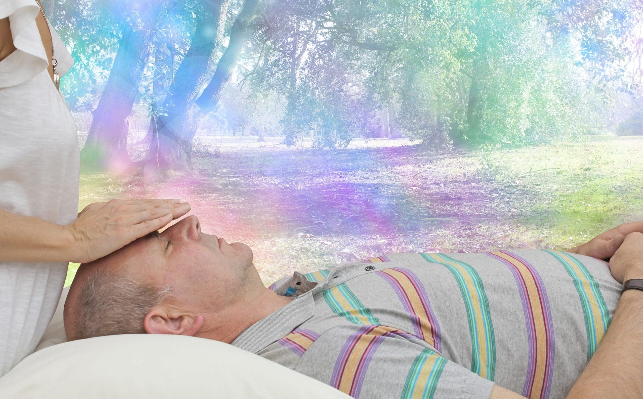 Man lying on the table receiving reiki treatment