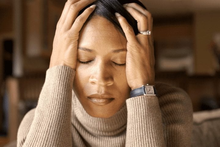 Women Holding Head from Migraine