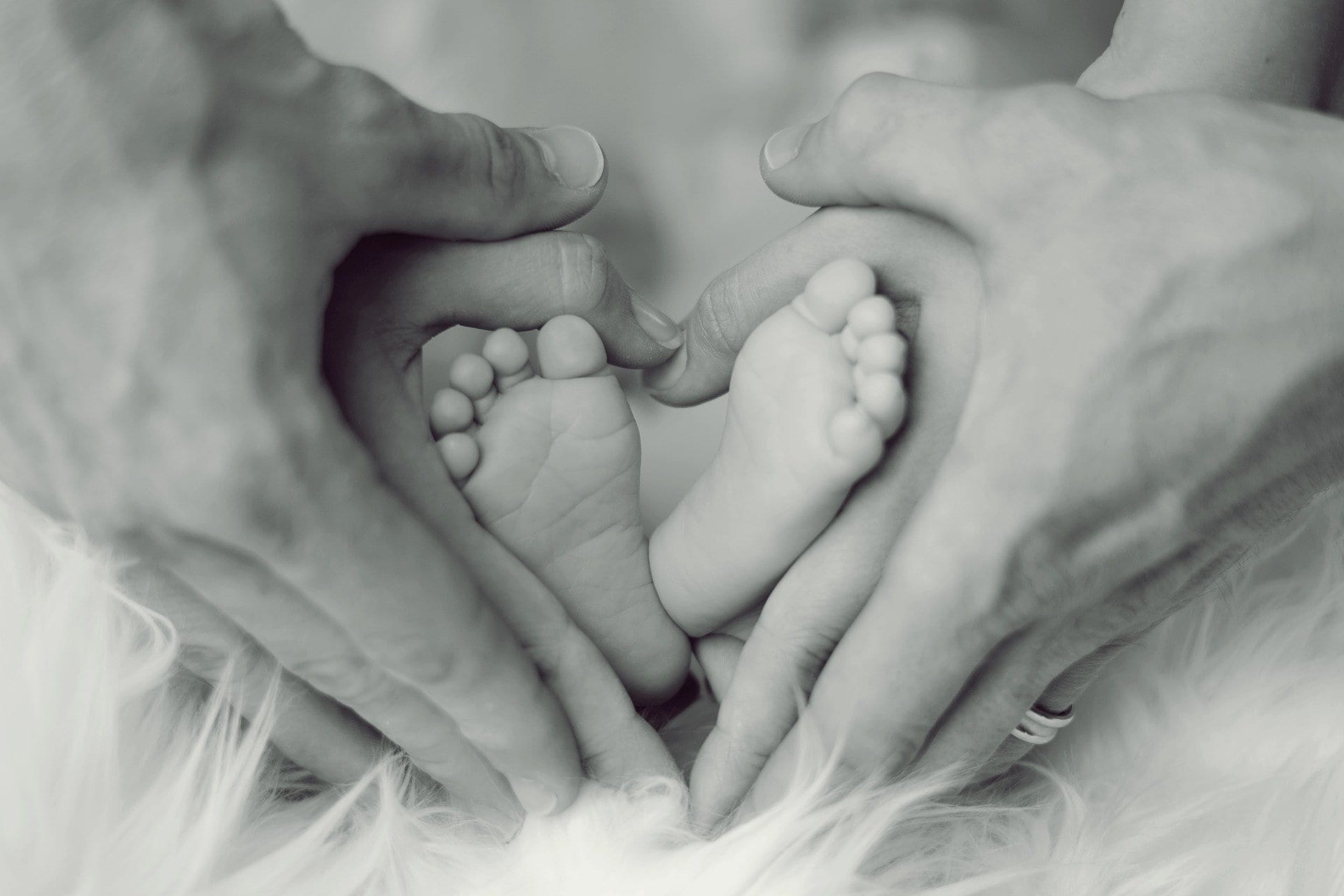 hands holding baby feet