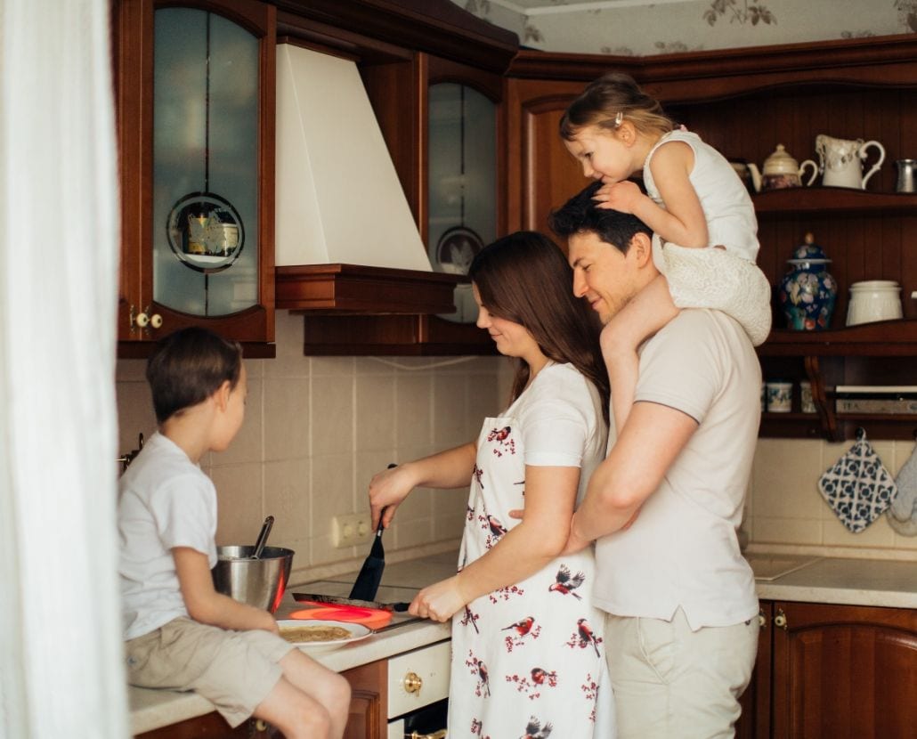 man woman children cooking