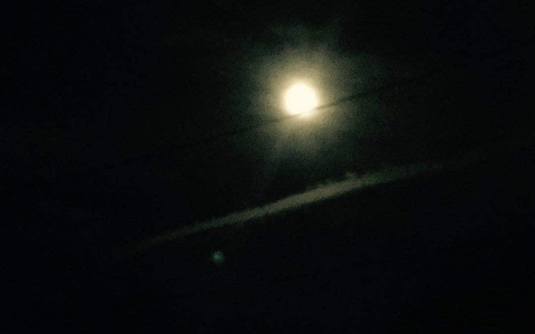 Beautiful full #moon with cloud streaks. There is a small #orb on left that was playing in the sky.