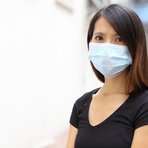 asian woman in blue mask