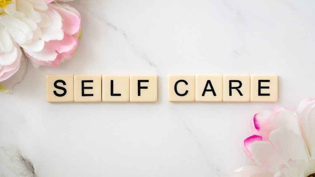 self care spell out on postcard